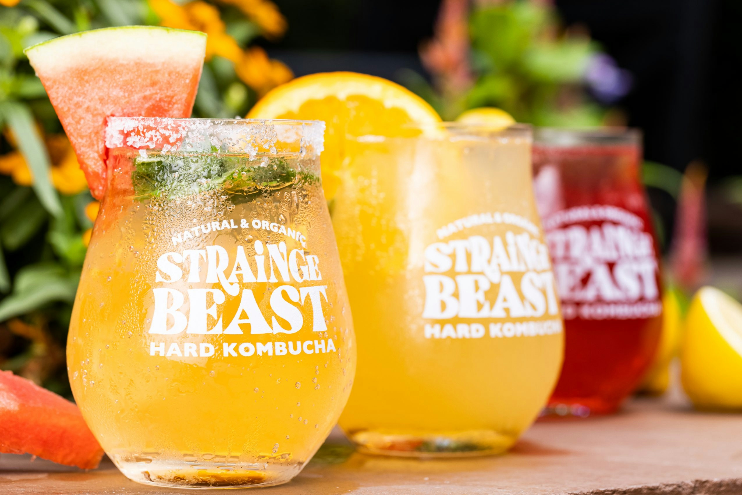 Strainge Beast hard kombucha in glasses with fruit