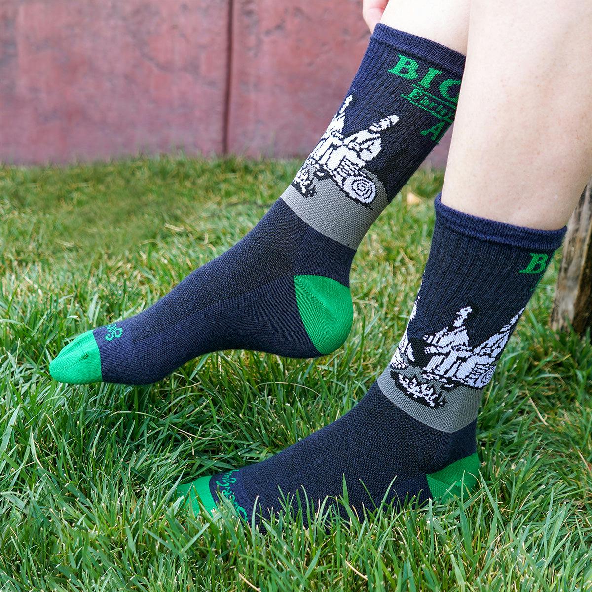 A person pulls on a pair of the Sierra Nevada Bigfoot socks