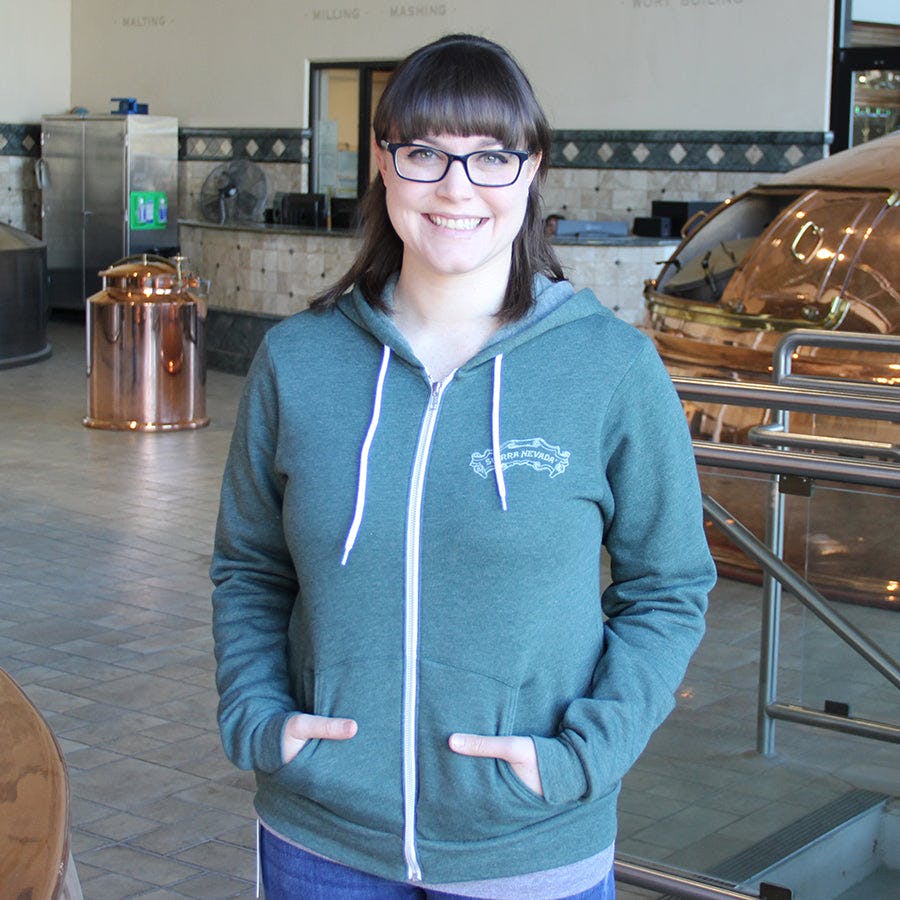 Woman with brunette hair and glasses wearing the Sierra Nevada Chalk Zip hoodie