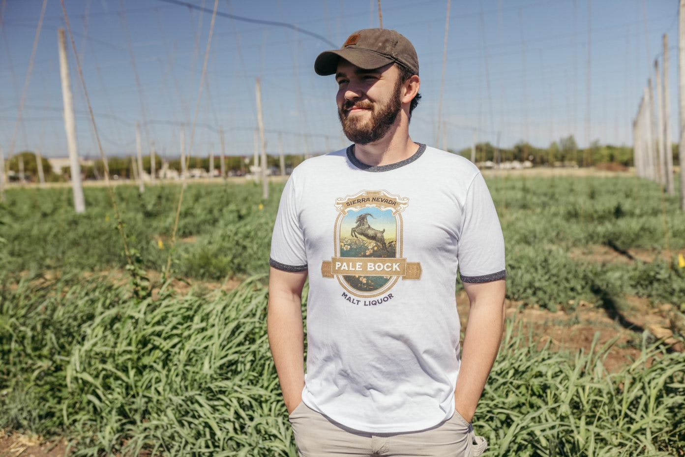 Man standing in a hop yard wearing Sierra Nevada Pale Bock tee