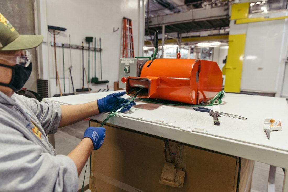 polyester straps being fed into a machine to be recycled