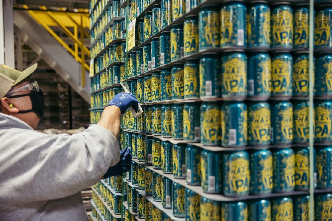 polyester straps being cut off of a pallet of beer