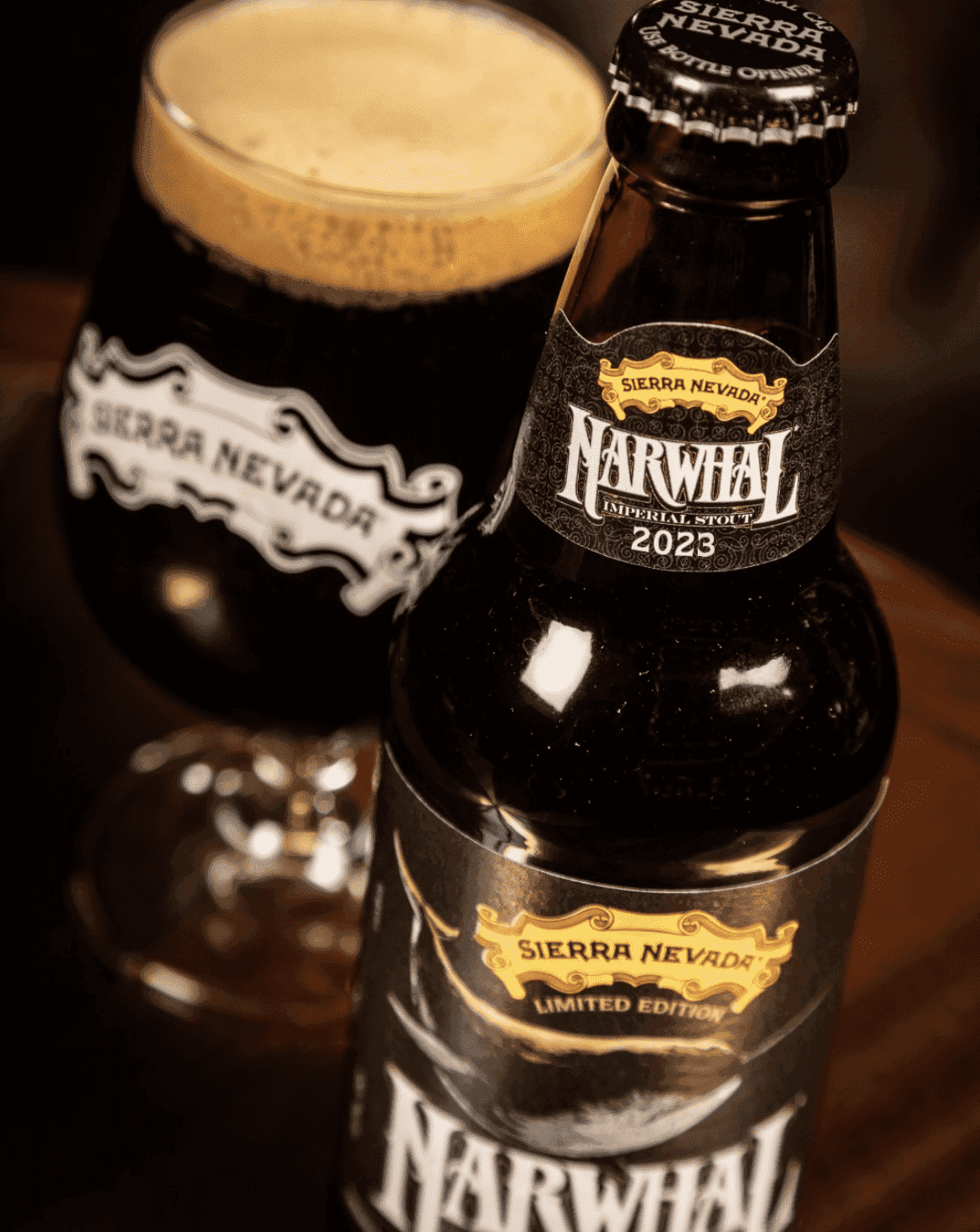 A close-up shot of a pint of Narwhal in a glass, sitting next to the bottle