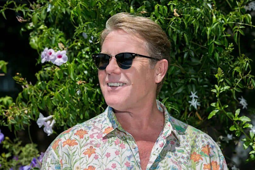 The English Beat standing in front of a plant and smiling